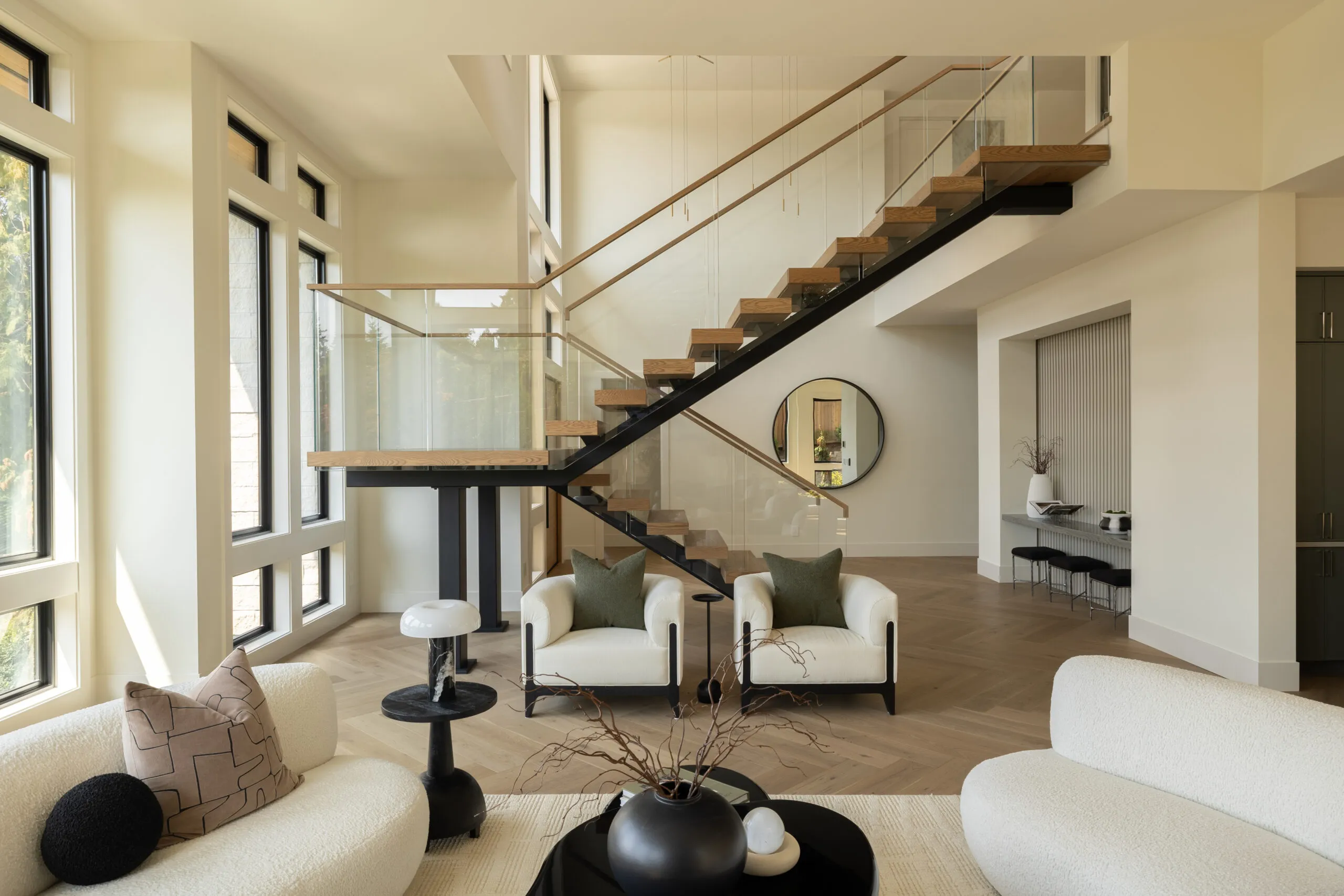 Beautiful interior image of modern living room in neutral colors and floating staircase.