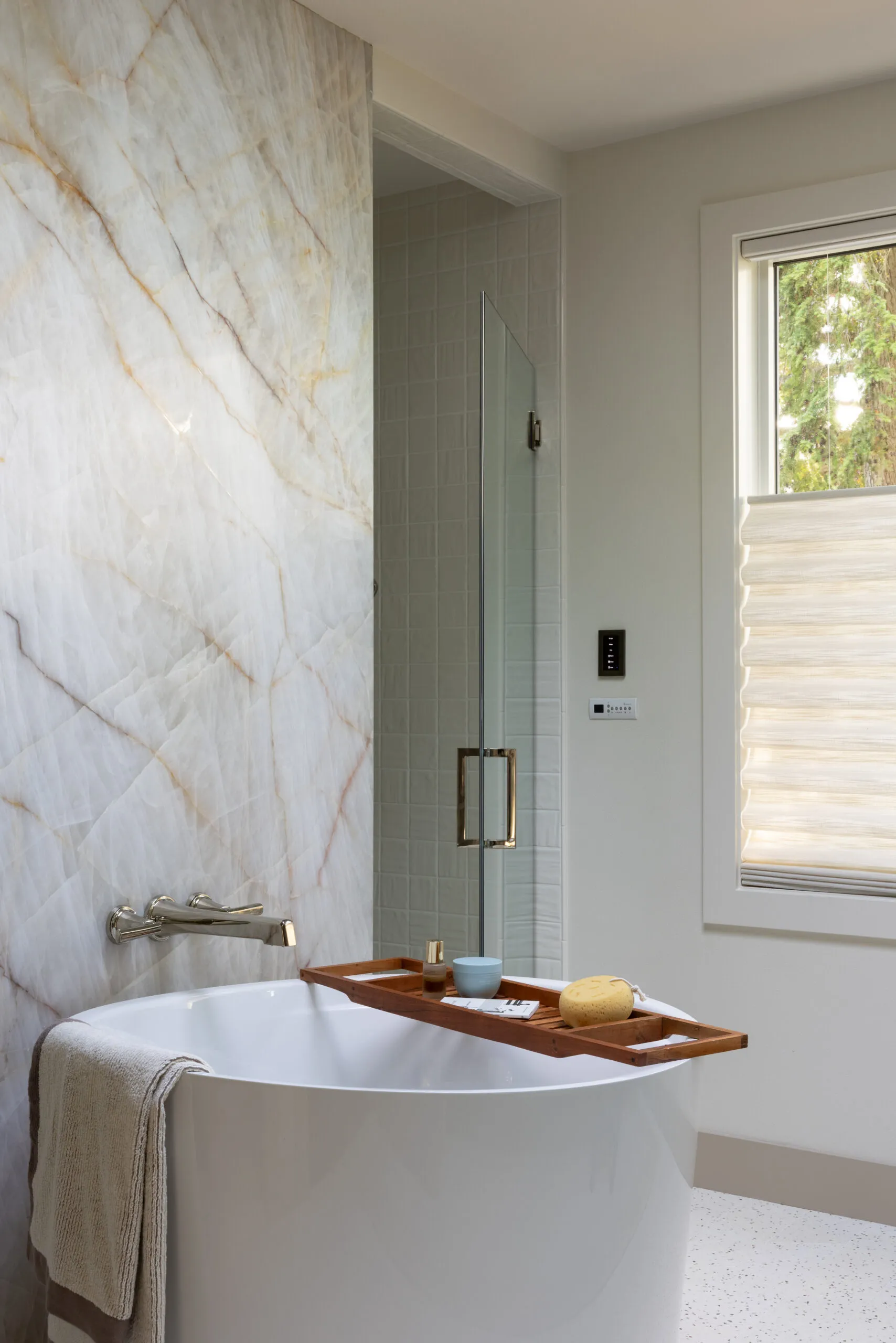 2026 Northwest Idea House primary bathroom with a natural stone wall and japanese soaking tub